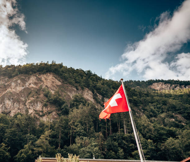 istock switzerland flag waving on the sky 1398654532