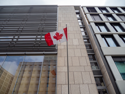 Windsor, Ontario, Canada - March 05, 2024:  Flags at half-mast in the downtown core of Windsor, Ontario, commemorating the life and death of ex Prime Minister, Brian Mulroney.