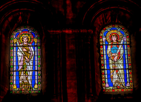 Kalety Miotek, Poland, January 1, 2023: Stained glass window in the church of St. Francis of Assisi in Miotek, Silesia, Poland seen from the outside in the evening. Saint Francis in the foreground