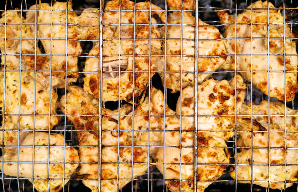 istock Grilled barbecue chicken meat on brazier close-up 1398662590