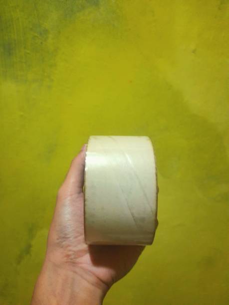 istock someone's hand holding plastic duct tape 1398665254