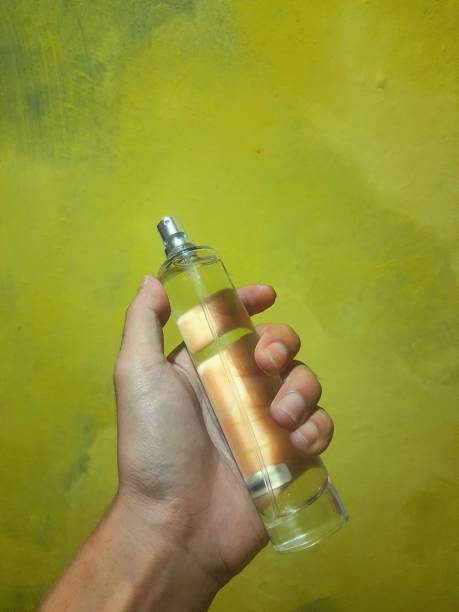 istock a person's hand holding a perfume bottle 1398665286