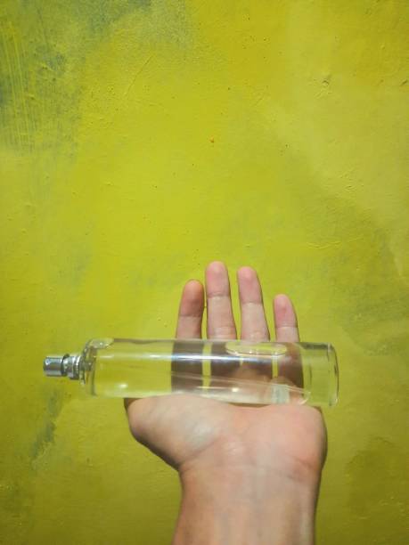 istock a person's hand holding a perfume bottle 1398665297