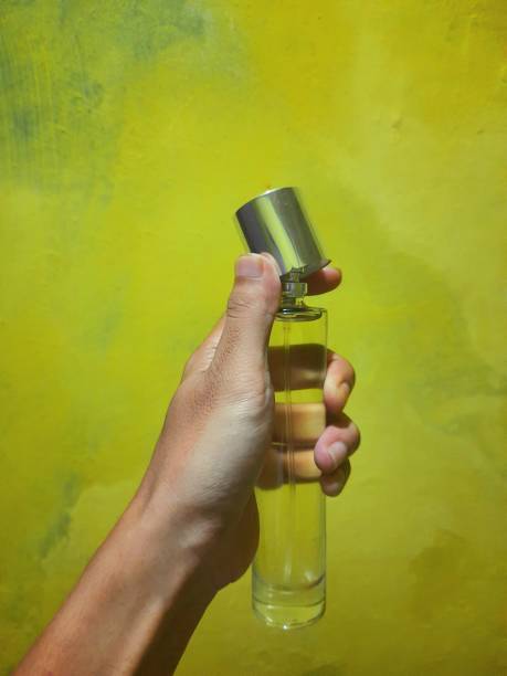 istock a person's hand holding a perfume bottle 1398665498