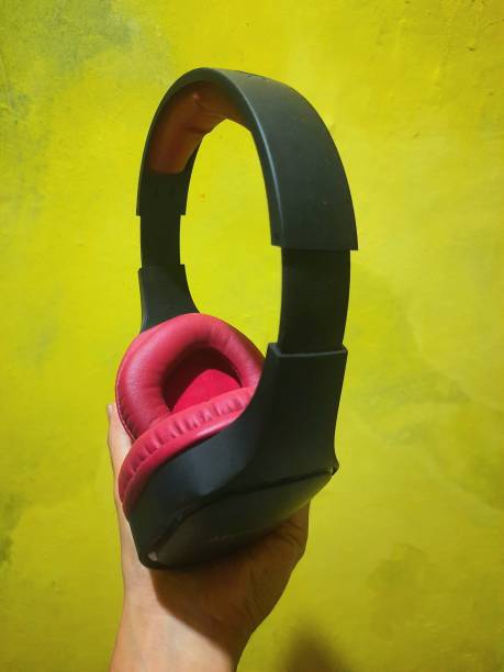 istock someone's hand holding earphones, bluetooth connection 1398665556