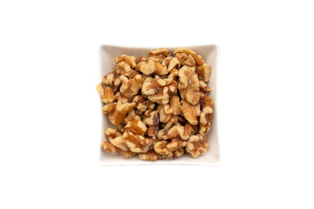 istock A white bowl with nuts. Isolated on white background. 1398666316