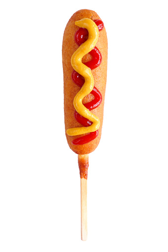 Corn dog with ketchup and mustard toppings isolated on a white background