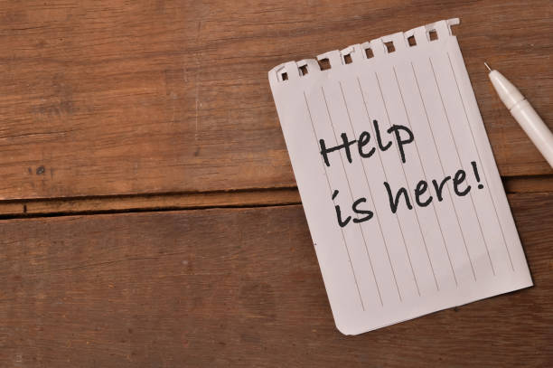 istock Pen and white paper written with HELP IS HERE! 1398670138