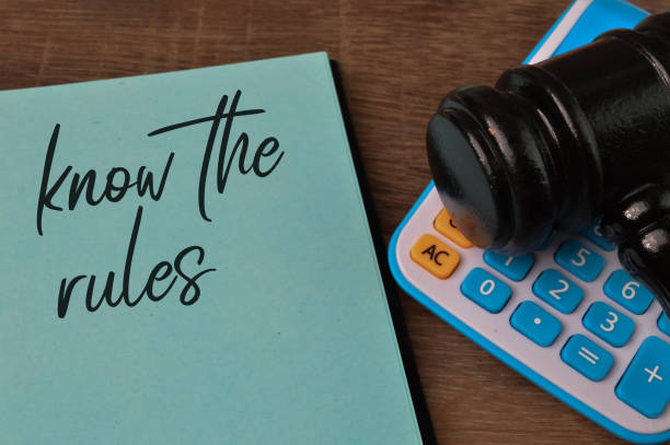 istock Judge gavel, calculator and notebook written with KNOW THE RULES. 1398671111