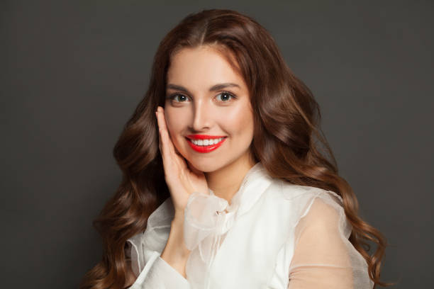 istock Young woman smiling on black background 1398671166