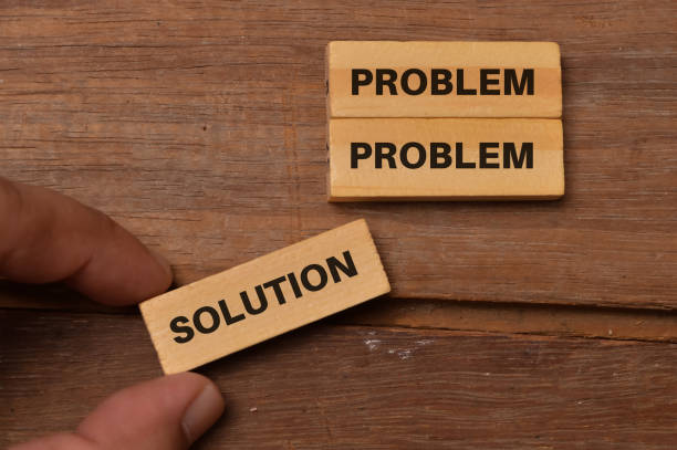 istock Concept of problem solving. Hand holding a wooden block with the word SOLUTION 1398672737