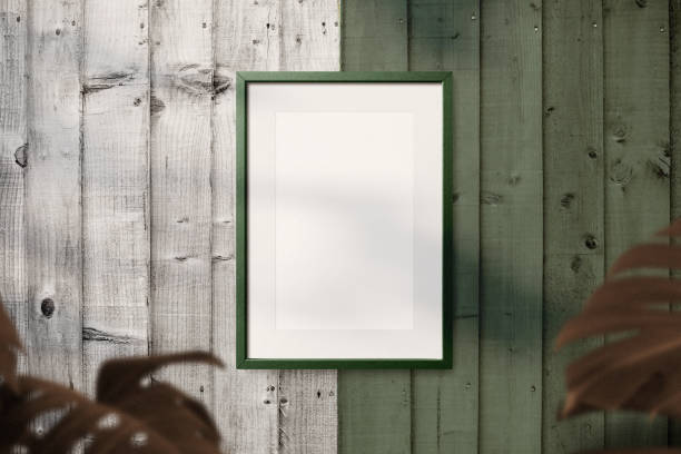 istock Clean minimal frame mockup on the wooden wall with leaves 1398673336
