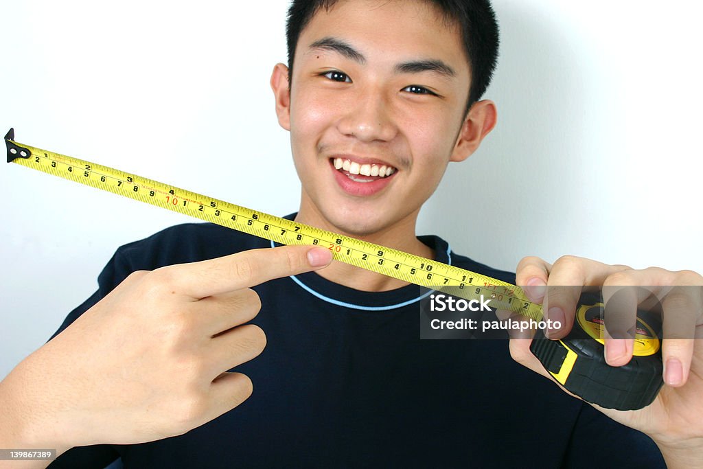 Rolling tape Young guy holding a rolling tape. Acute Angle Stock Photo