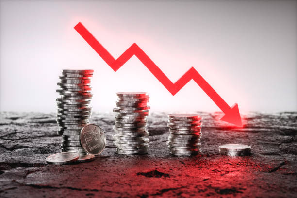 istock Russian Ruble coins stacked from higher to lower with a falling red arrow. 3d rendering 1398674724