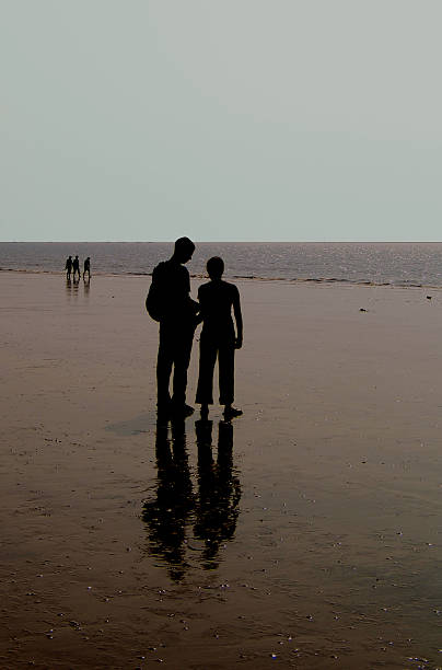 couple on the beach stock photo