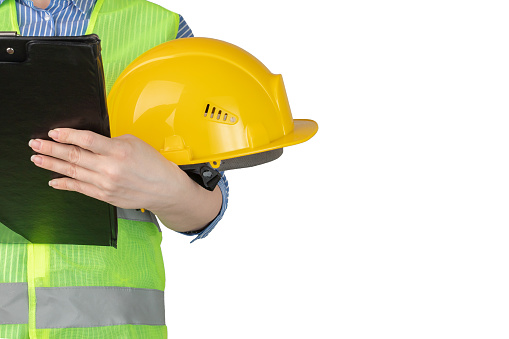 labor protection specialist, female builder engineer with a clipboard on a white background, inspector worker in builder's industrial clothing