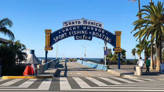 The iconic sign for the Santa Monica Pier on a sunny morning