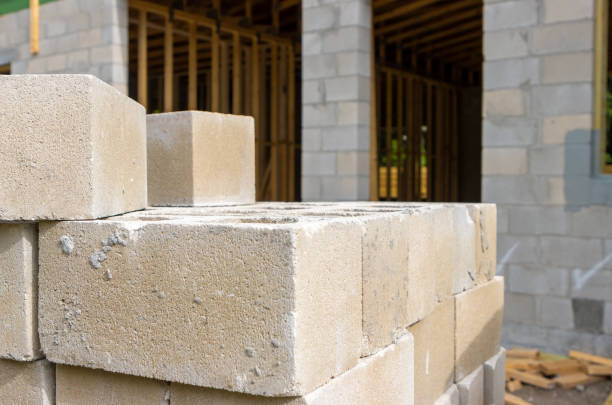 istock Stacks of cinder blocks outside home construction site 1398676817