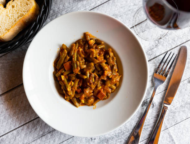 istock Dish of green beans with ham and tomatoes 1398680693