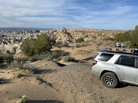 Merzouga, Morocco - September 25, 2019: Black offroad vehicle Toyota Land Cruiser Prado 150 between the dunes of the Sahara desert.
