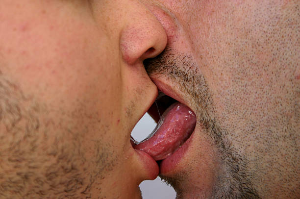 男性の舌 - gay man homosexual men kissing ストックフォトと画像