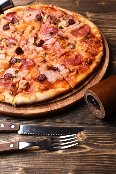 istock Pizza with bacon and cheese on wooden background 1398682197