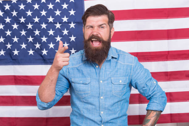 istock victory and freedom. education and business in america. Students exchange program. American patriotic people. USA Independence Day 4th of July. pointing finger. happy man at USA national flag 1398682392