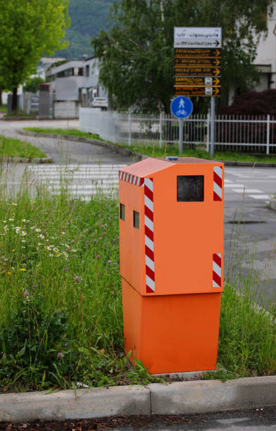istock Orange traffic enforcement camera on the side of road 1398682816