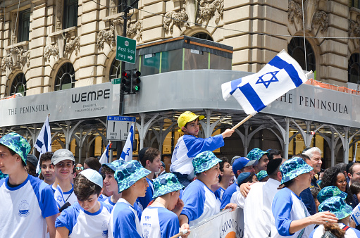 Young participant is seen holding Israeli flag and march way up Fifth Avenue in New York City during the annual Israel Parade on May 22, 2022.