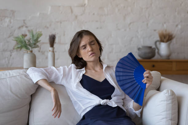 istock Exhausted overheated girl feeling hot at home 1398683787