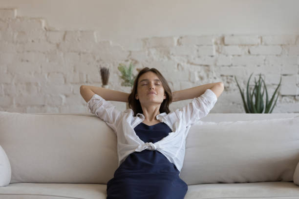 istock Serene sleepy millennial girl resting on sofa, leaning on back 1398683789