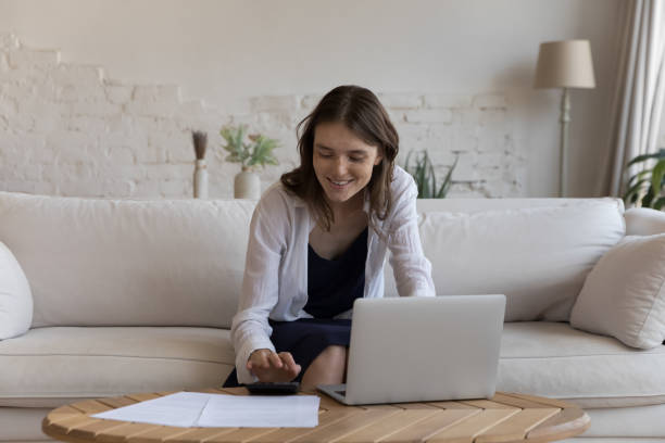 istock Positive satisfied young tenant woman doing accounting work 1398683796