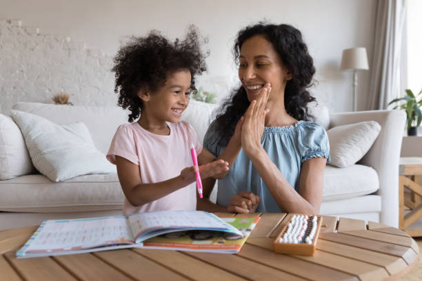 istock Excited mom and cheerful kid girl clapping high five hands 1398683836