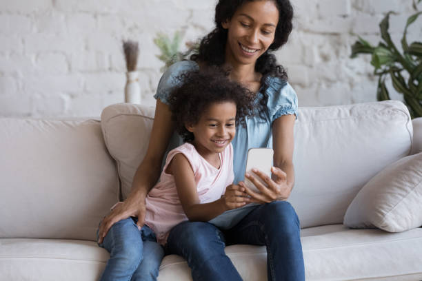 istock Happy mom and cheerful daughter kid making video call 1398683981