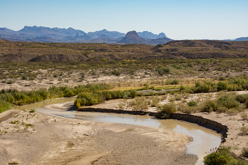 Border river between the USA and Mexico with the Chisos Mountains in the background