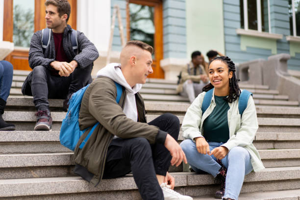 istock A young couple talking while sitting on the steps of the campus 1398685247