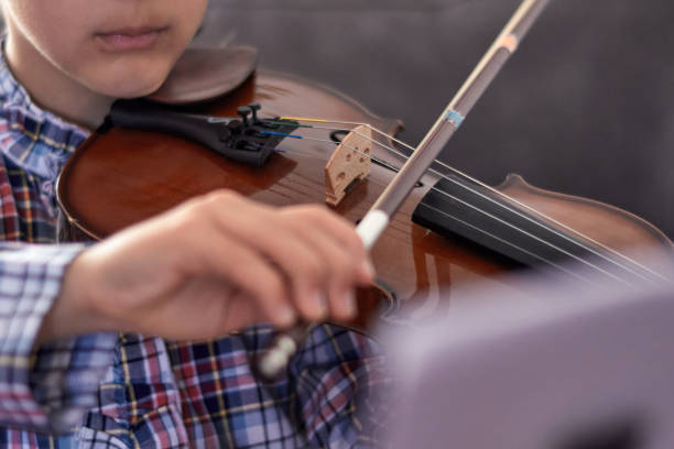 istock Selective blur of a hand holding a violin bow. 1398685311