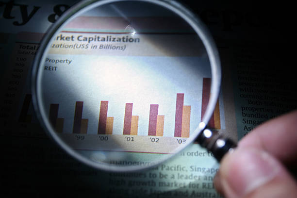 Magnifying glass checking the small print on a contract.