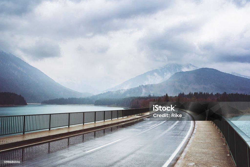 Road over the Sylvenstein reservoir and Isar in Bavaria on a rainy day. Road over the Sylvenstein Lake and Isar in Bavaria on a rainy day. Adventure Stock Photo