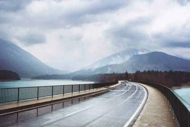 Road over the Sylvenstein Lake and Isar in Bavaria on a rainy day.