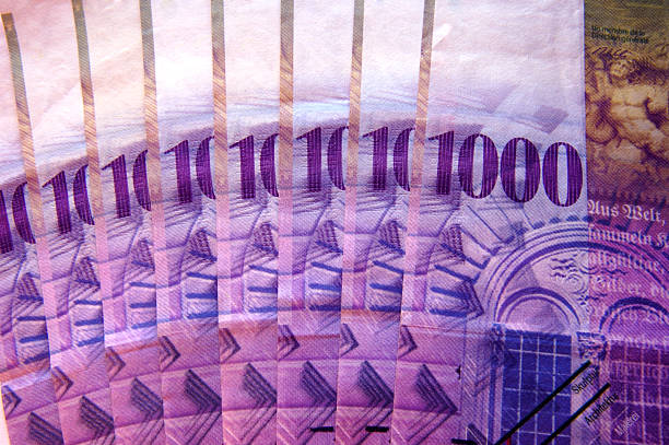 Close up detail of eight Swiss 1000 franc notes fanned out.