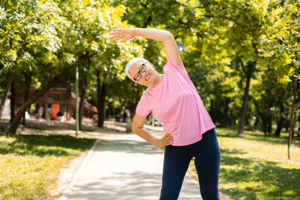 istock Senior woman stretching back 1398687630