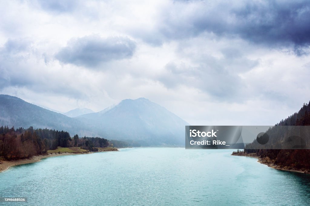 Rainy day at Sylvenstein Lake in Upper Bavaria with a view of the foggy mountains. Bavaria Stock Photo