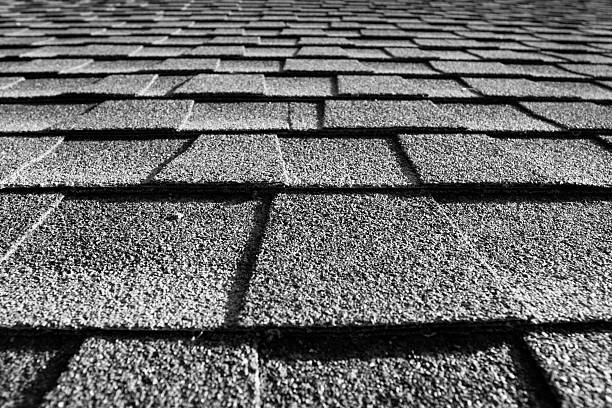 A close-up of the gray shingles on the roof of the house close up of roof shingles black and white wood shingle photos stock pictures, royalty-free photos & images