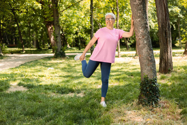 istock Senior woman stretching back 1398688830