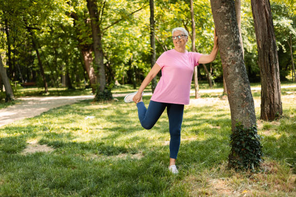 istock Senior woman stretching back 1398688838