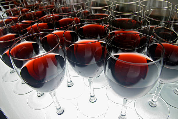 A lot of wine glasses filled with red wine stock photo