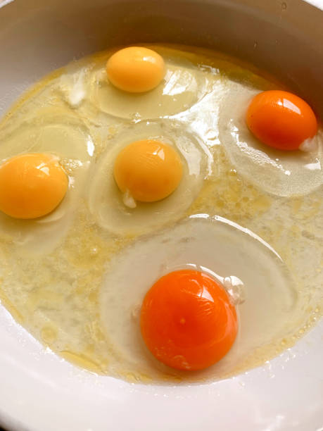 istock Egg Whites & Yellow/Orange Egg Yokes in a Pan Ready to be Cooked - Yellow Cage-free Eggs Versus Orange-Colored Pasture Raised Eggs Cooking in a Pan SunnySide Up in Bright Natural Light 1398689555