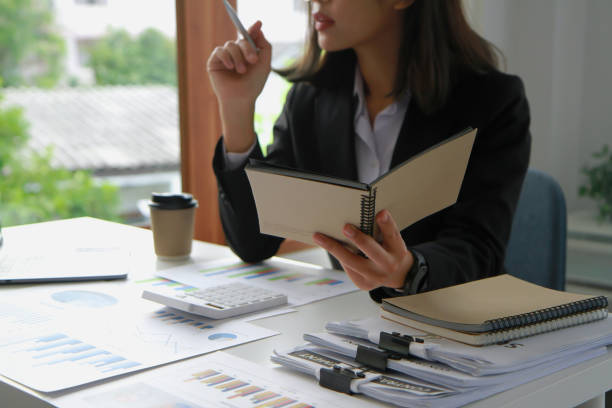 istock Financial advisor calculating numbers datasheets graphs charts reports marketing research development planning management strategy analysis financial accounting. Business office concept. 1398690072