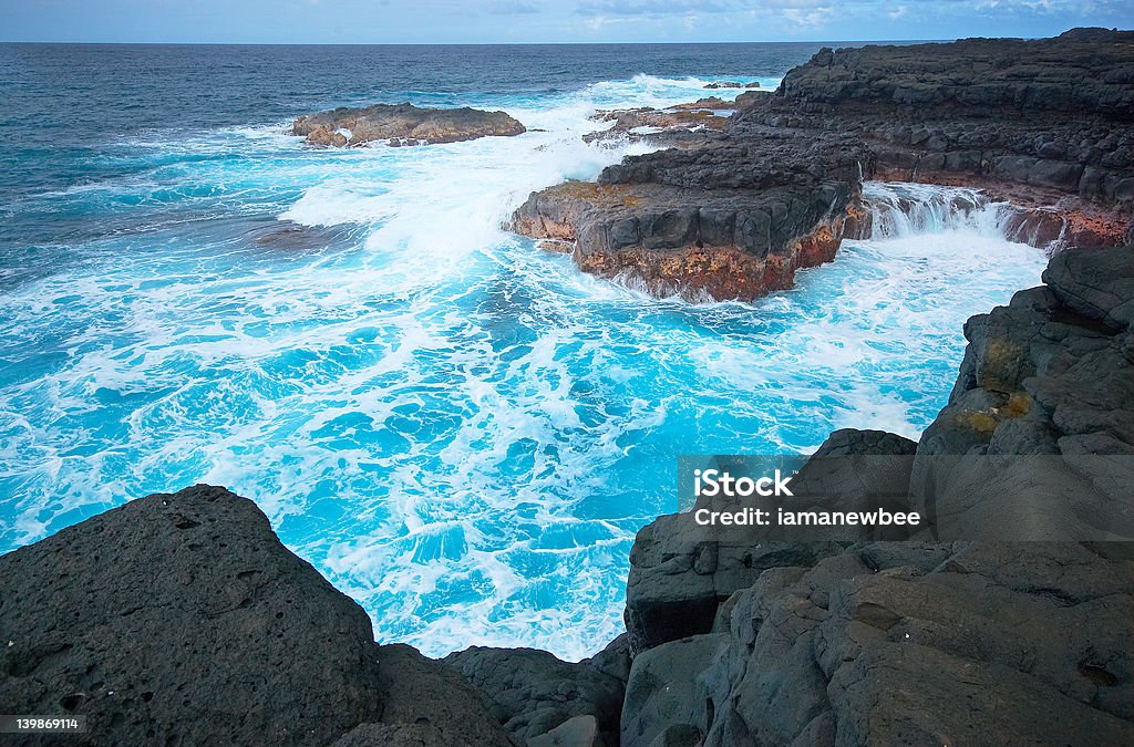 Queen's Bath, Kauai, HI The cliffs and waves at Queen's Bath are the best kept secret until recent years. This is one of the photos in the Series001 Kauai Hawaii Under Wide Angle Lens. Blue Stock Photo